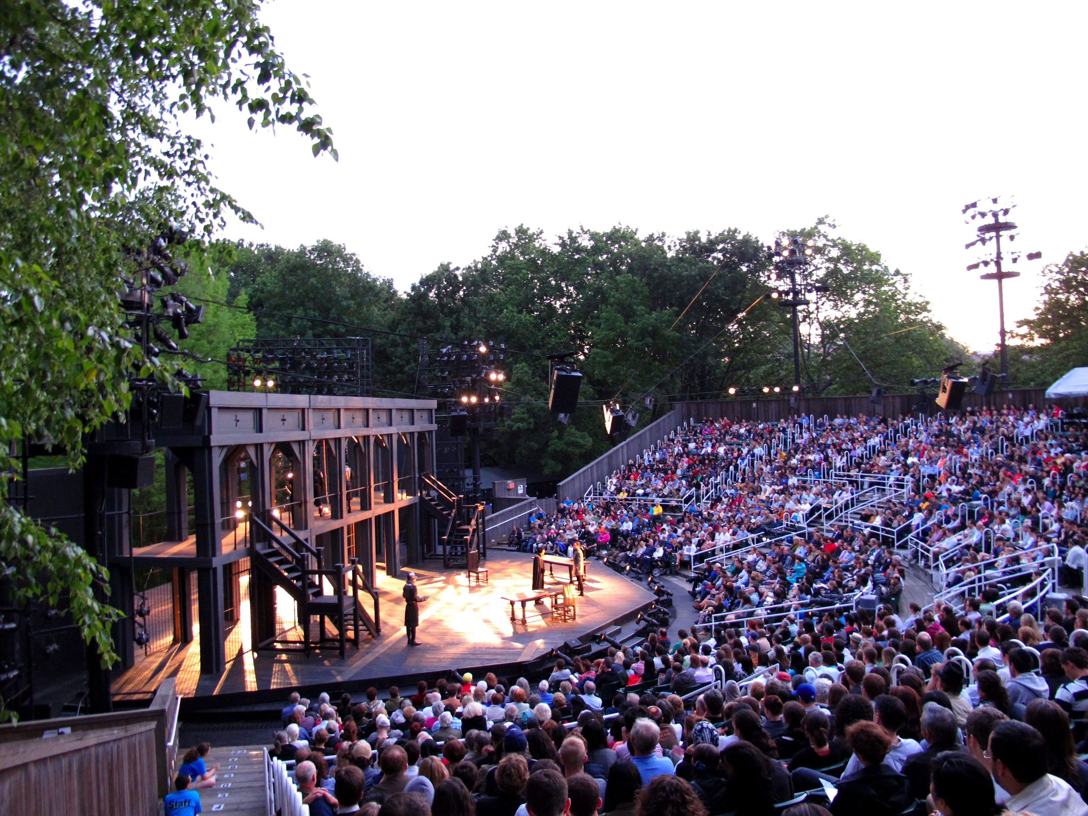 A large outdoor amphitheater filled with an enthusiastic audience